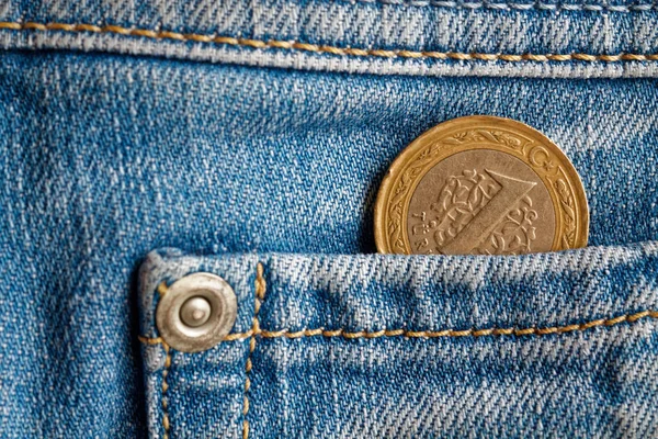 Turkish coin with a denomination of 1 lira in the pocket of light blue denim jeans