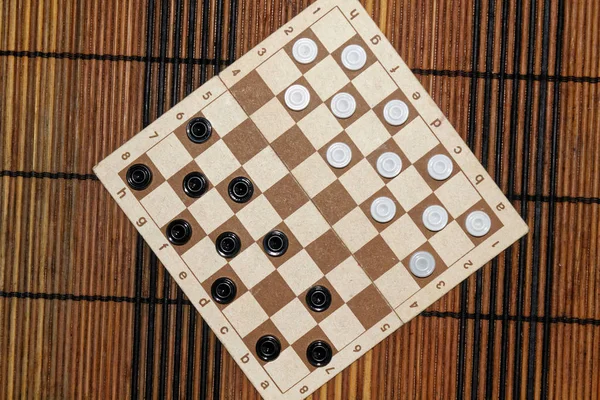 Checkers in checkerboard ready for playing. Game concept. Board game. Hobby. checkers on the playing field for a game.