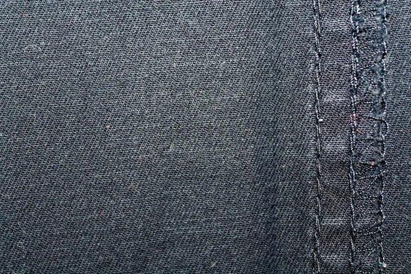 Blue denim macro texture with seam for jeans background — Stock Photo, Image