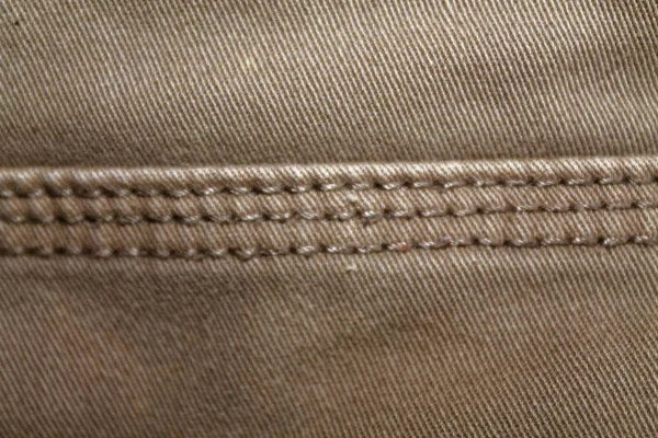 Detaljeret closeup denim. Vintage beige jeans med snørebånd, god til baggrund - Stock-foto