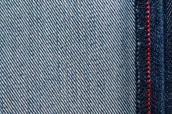 Denim textuur met rode naad voor jeans achtergrond — Stockfoto