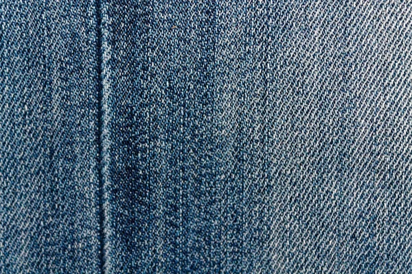 Blue denim macro texture with seam for jeans background — Stock Photo, Image