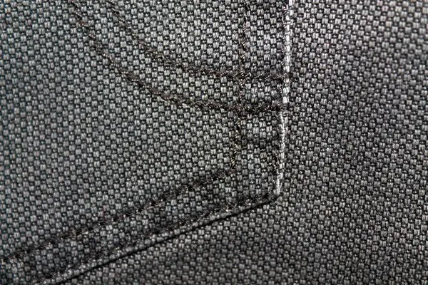 Closeup detalhado de denim grungy em branco. Jeans cinza vintage com atacadores, bom para fundo — Fotografia de Stock