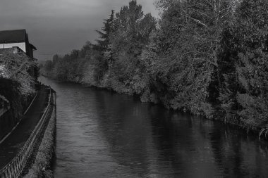 Su kanalı (kanal) ve ağaçlar ve binalar Robbecoo sul Naviglio, İtalya için yansımaları
