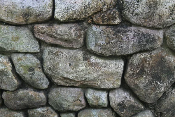Steinmauer für Hintergrund oder Felsen raue Textur — Stockfoto