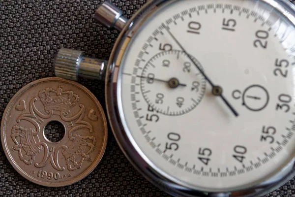 Denmark coin with a denomination of five crown (krone) (back side) and stopwatch on brown denim backdrop - business background — Stock Photo, Image