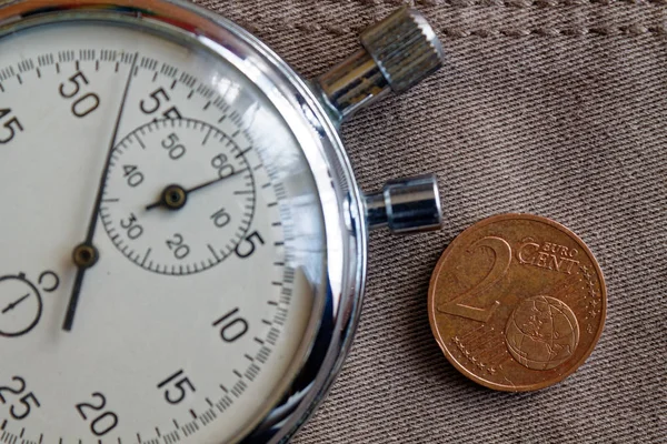 Κέρμα ευρώ ονομαστικής αξίας 2 ευρώ σεντς και χρονόμετρο για παλιό σκηνικό μπεζ τζιν - επιχειρησης — Φωτογραφία Αρχείου