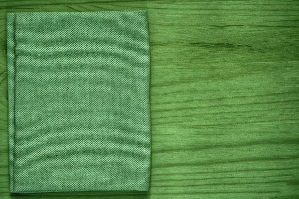 Ultra green Postcard sample, linen fabric surface on wooden table with free copyspace for greeting text, for mock-up or designer use, book cover sample