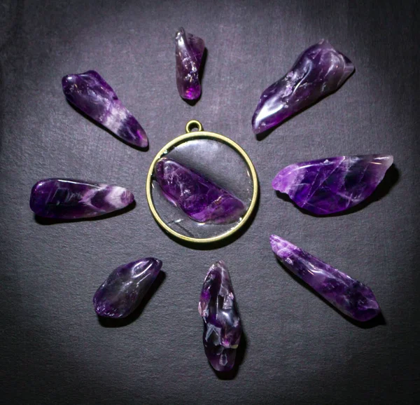 Top view on purple amethysts and necklace on dark background — Stock Photo, Image