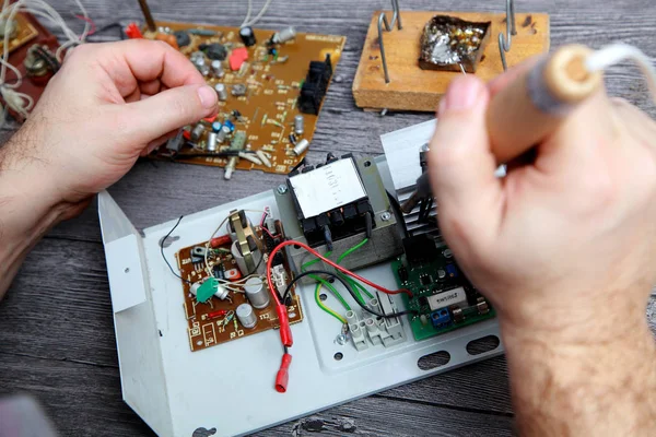 Work of the master on repair of electric equipment, it soldering details