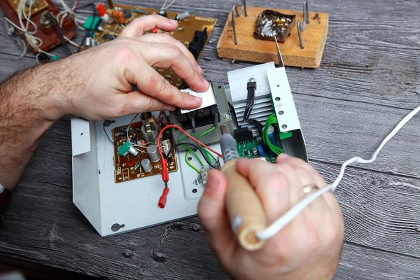 Work of the master on repair of the radio electronic equipment, it is soldering of details and chips