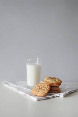 Stack of handmade oatmeal cookies with glass of milk