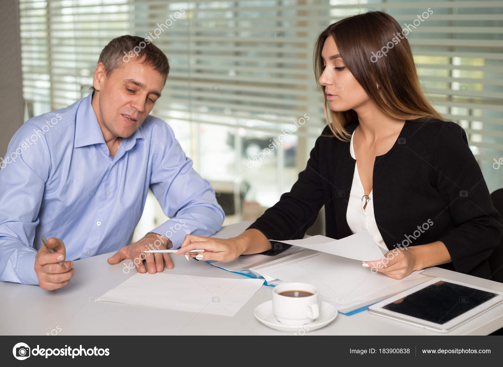 A Man And A Woman Work In An Office And Talking Stock Photo