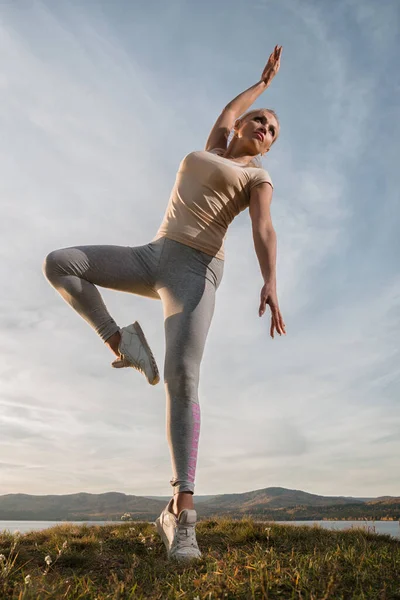 Vacker Kvinna Fitness Instruktör Lätta Kläder Tåg Stranden Mot Himlen — Stockfoto