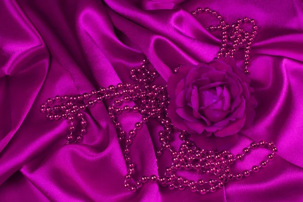 Rosa ros och pärlor på satin — Stockfoto