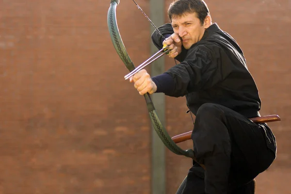 Archery in black kimono — Stock Photo, Image