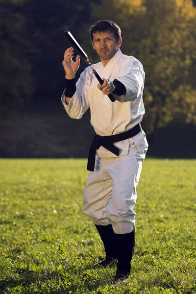 White ninja with nunchaku — Stock Photo, Image