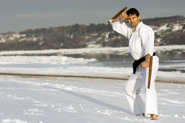 Practicing martial arts with tonfa in the snow — Stock Photo, Image