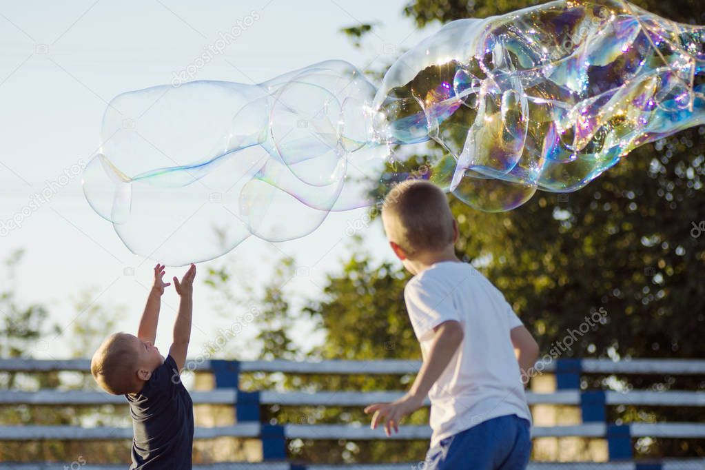 boys playing with soap bubbles