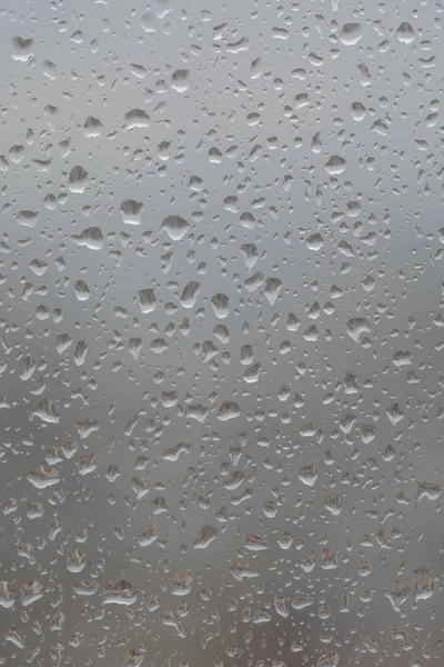 Капли дождя на окно, на размытом фоне города — стоковое фото