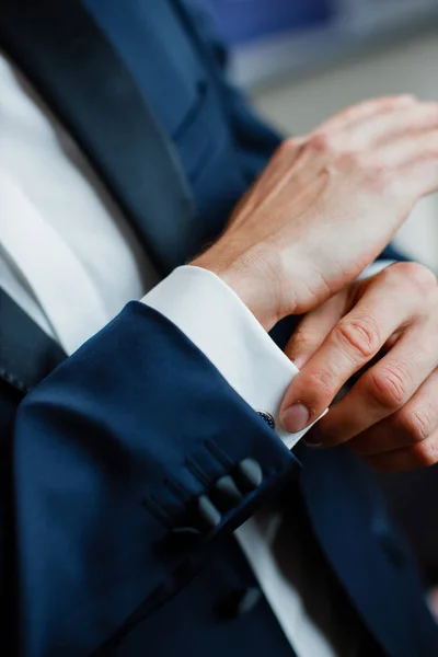 Groom in suit before wedding ceremony. Groom getting ready