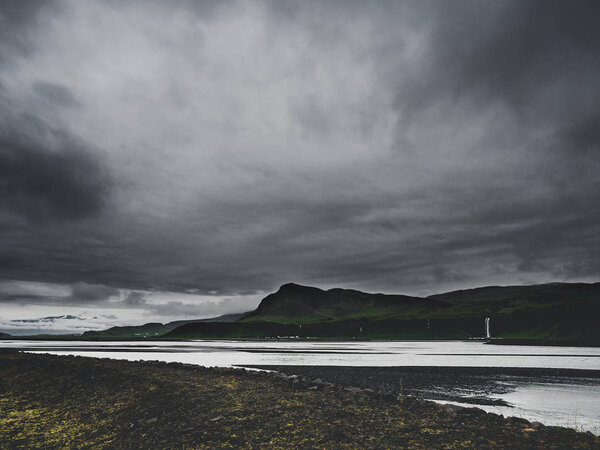 gloomy landscape with river and mountains in Iceland