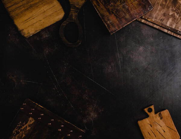 top view of wooden cutting boards on black surface