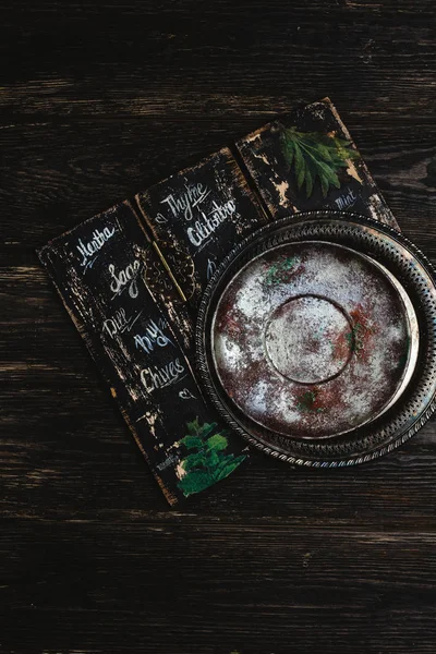 Top view of empty rustic metal tray on dark wooden background — Stock Photo