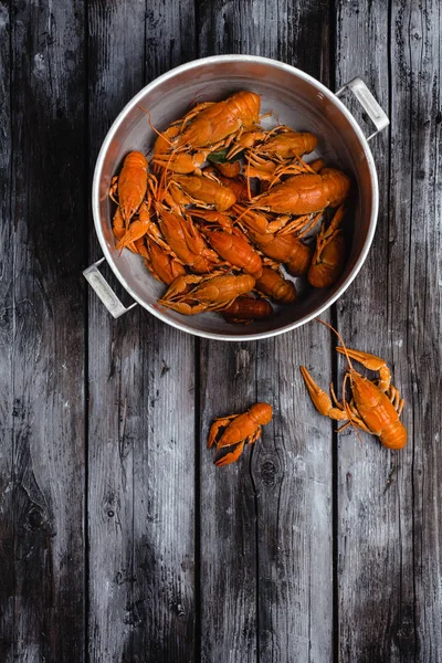 Top view of gourmet lobsters in pan on rustic wooden table — Stock Photo