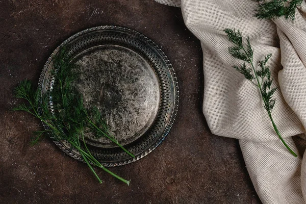 Top view of vintage plate with fennel and tablecloth on dark surface — Stock Photo