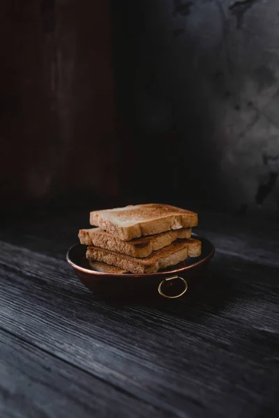 Close up view of toasts on plate on wooden tabletop — Stock Photo