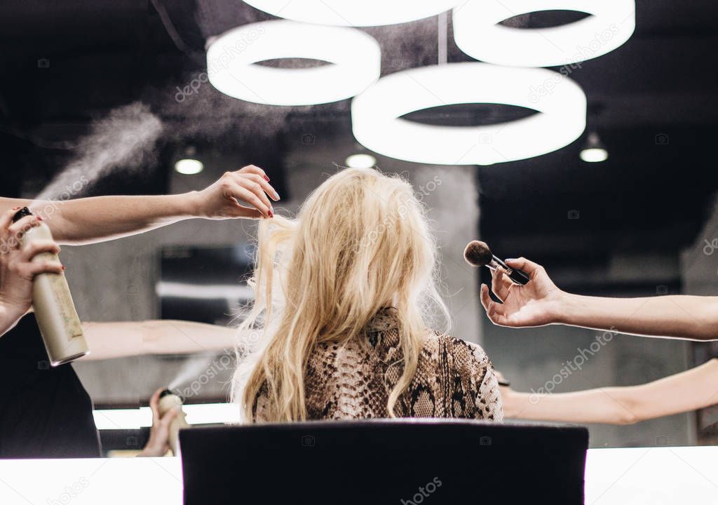Blond woman in beauty salon, beauty professionals at work