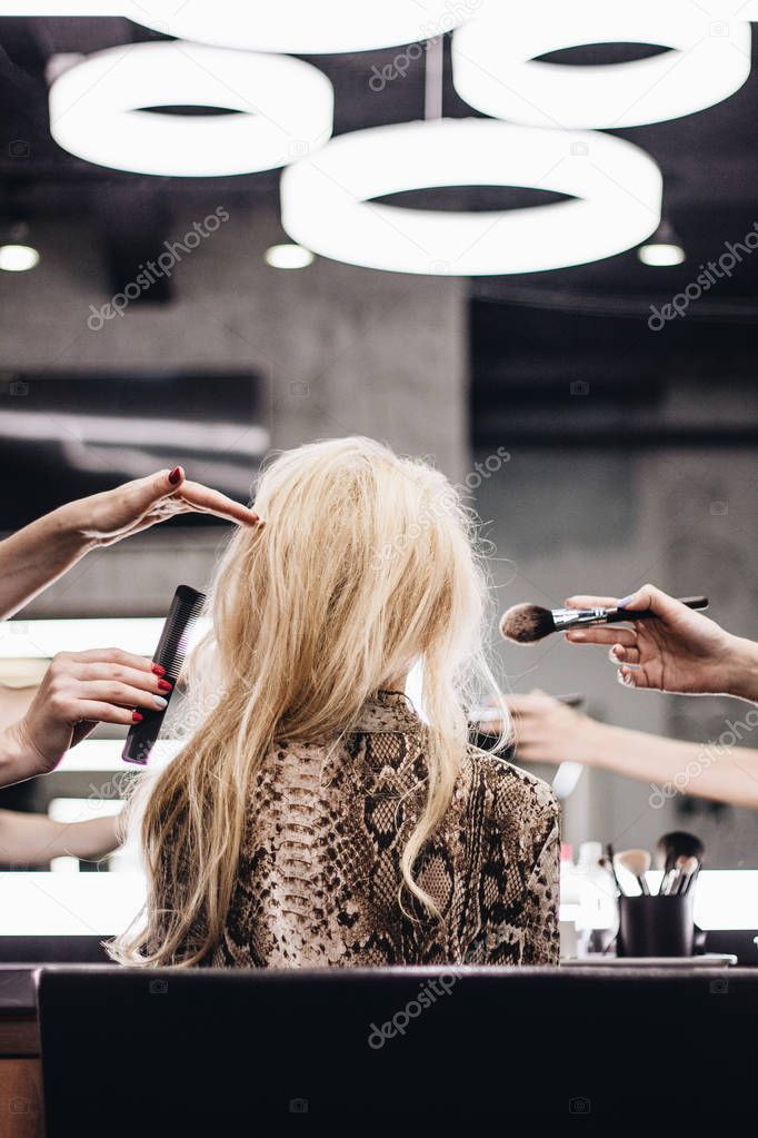 Blond woman in beauty salon, beauty professionals at work