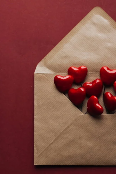 Envelope with red hearts on red background. Valentine's day concept