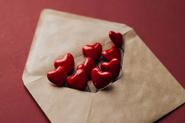 Envelope with red hearts on red background. Valentine\'s day concept