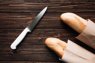 lezzetli taze gevrek Fransız loafs ve ahşap masa üzerinde bıçak