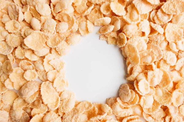 round frame of delicious crispy cornflakes on white background,  healthy breakfast