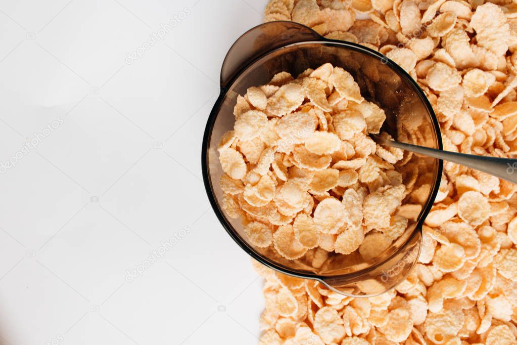 delicious crispy cornflakes in bowl on white background,  healthy breakfast