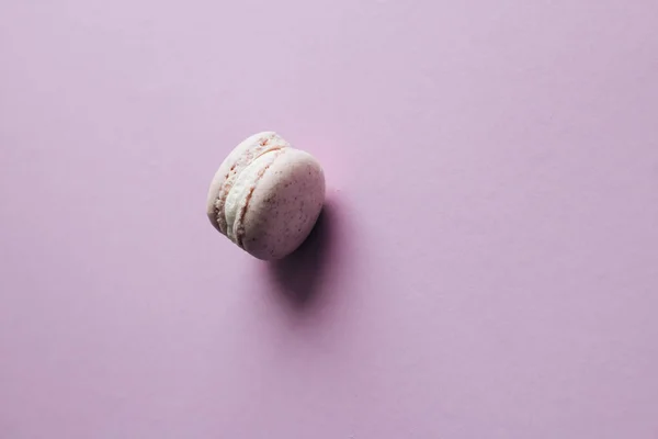 stock image delicious macaroon on purple table, sweet dessert 