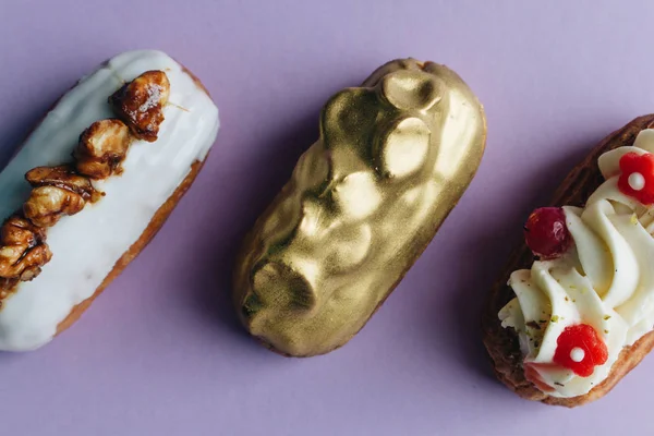 three assorted delicious sweets on purple background