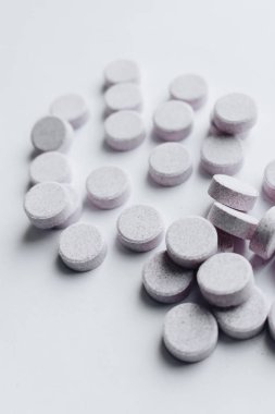 scatterded white pills on white background