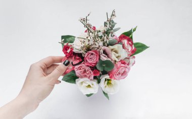 female hand touching beautiful spring bouquet with tender flowers 