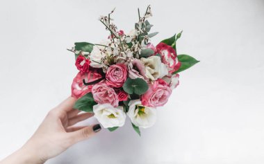 female hand touching beautiful spring bouquet with tender flowers 