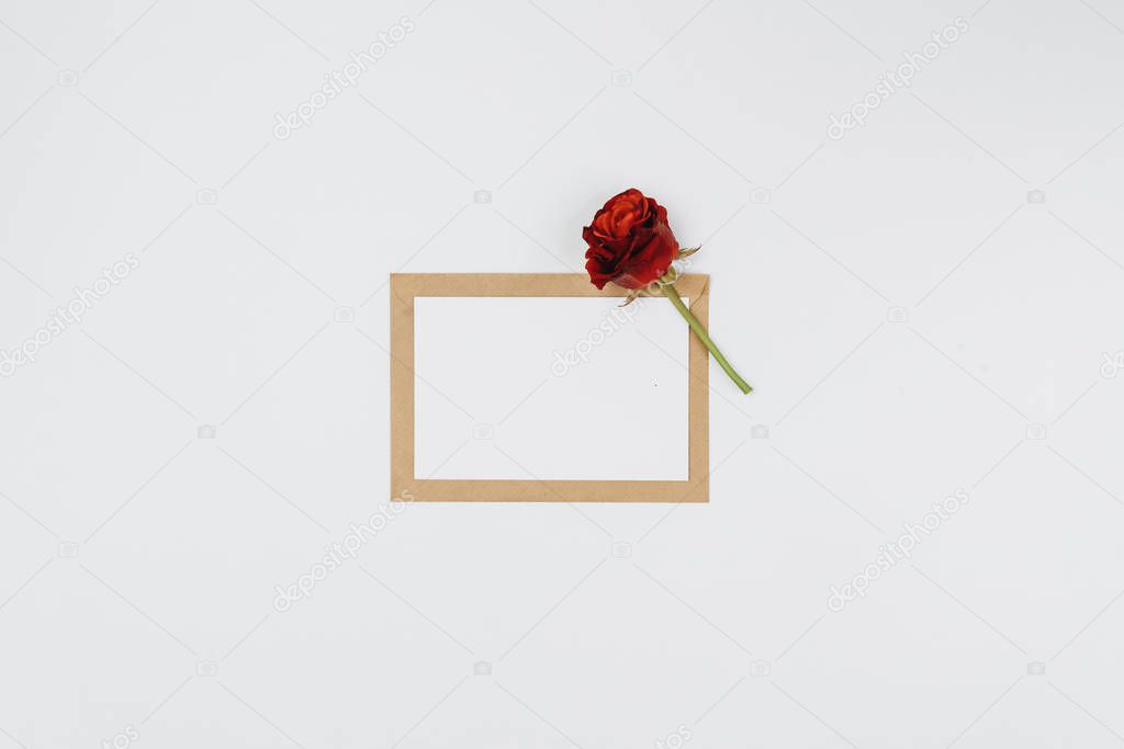blank greeting card and red rose 