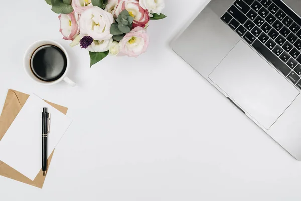 top view of workspace desk with supplies and notebook, coffee, diary and stationery on white background, flat