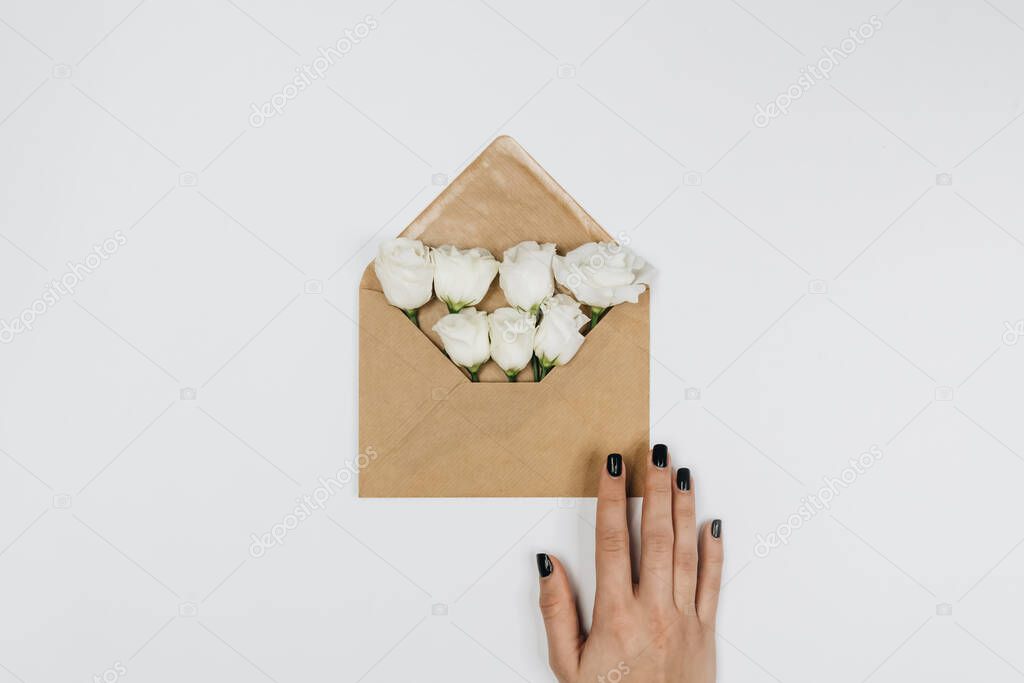 An envelope with flowers. Top view. Writing a letter. 