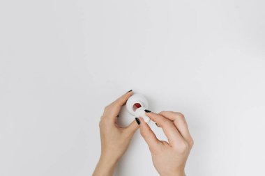  Whit 'e bırakılmış, elleri ve bir şişe losyonlu bir kadın resmi.