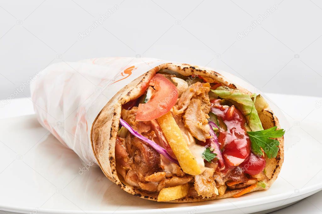 shawarma with sauce on white background