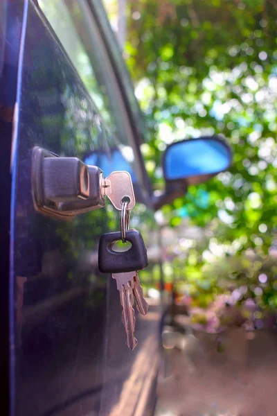 Car keys in a door lock close-up with copy space, blurred background