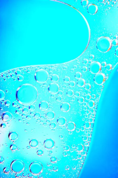 abstraction of drops on the glass top view on a color blurred background, Perfumery